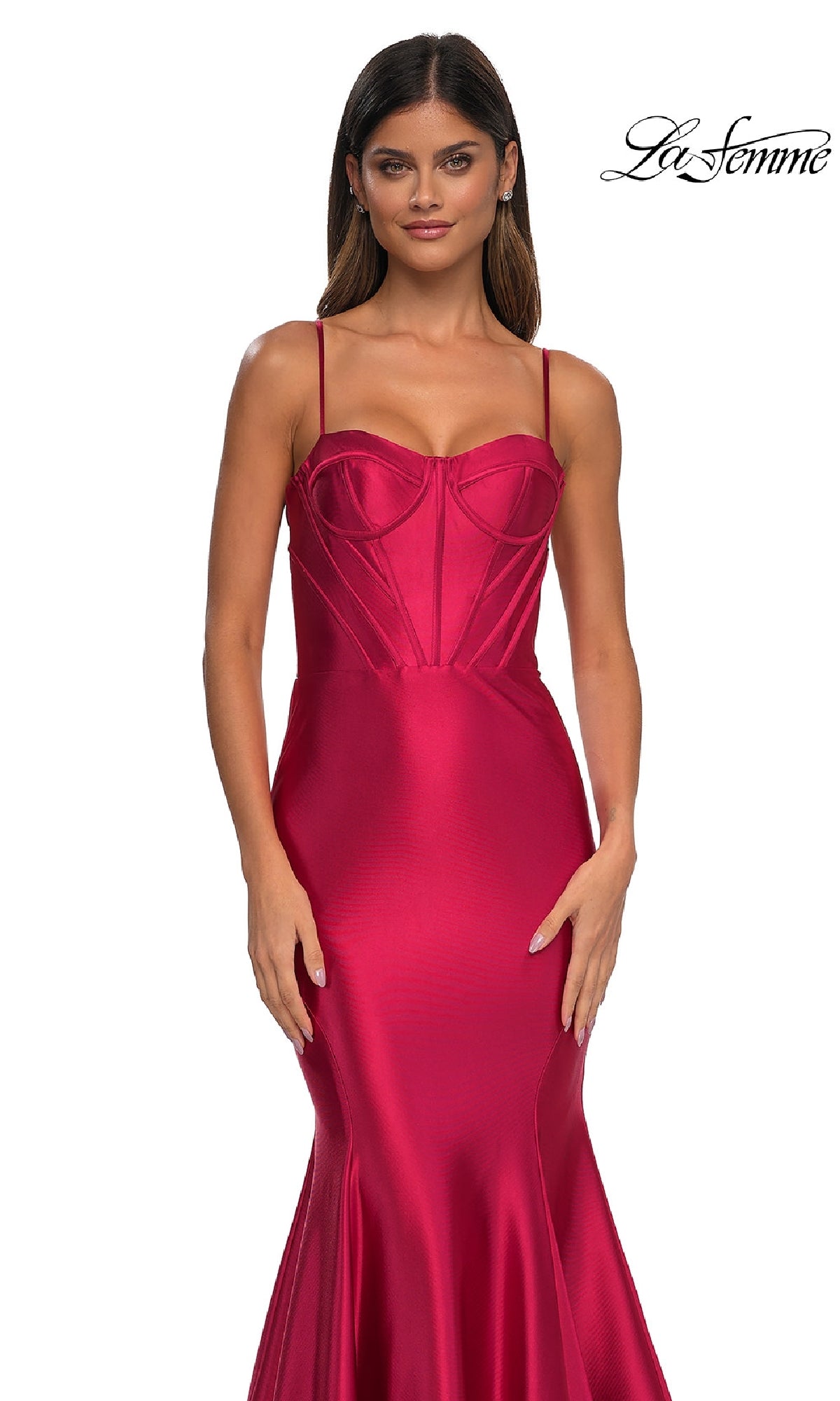 Woman in a fitted, sleeveless Long Corset Mermaid Prom Dress (La Femme 32555) in red, featuring thin straps and visible seam details, stands against a white background.